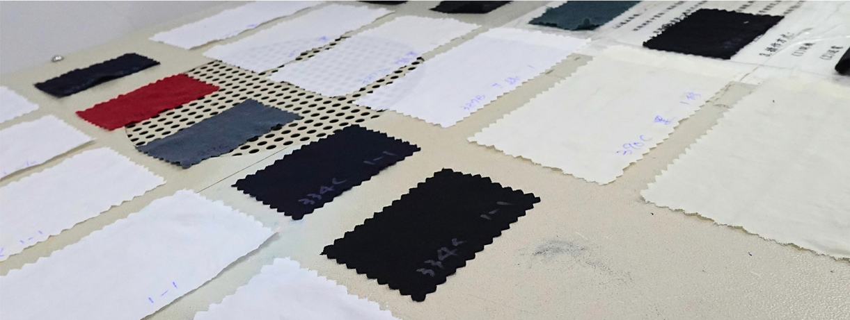 Dry fabric swatches laid out for colorfastness evaluation