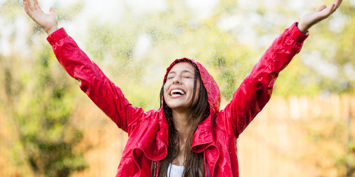 Person wearing a red water-repellent jacket in outdoor rain