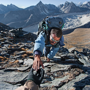 Mountaineer climbing in functional outdoor wear