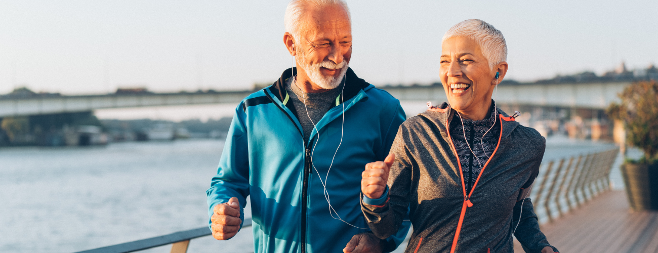 A couple jogging in functional outdoor jackets &ndash; breathable, lightweight, and weather-resistant activewear