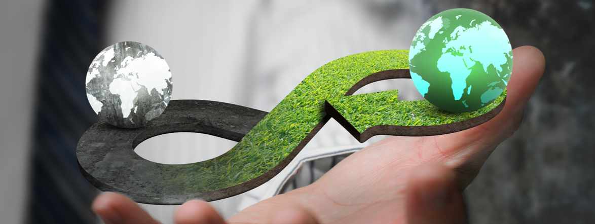 A hand holding an infinity-loop symbol with two globes representing circular design and mono-material sustainability