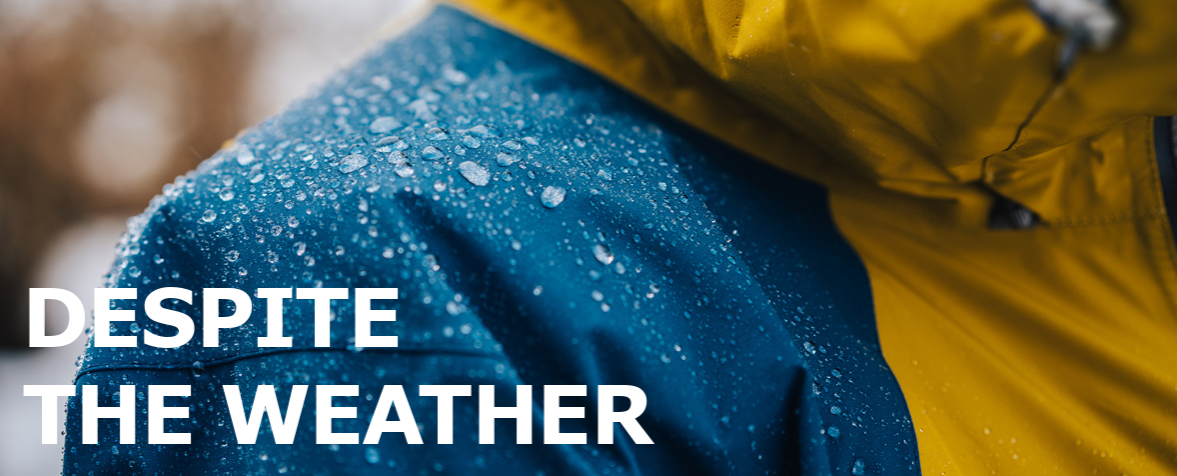 Close-up of water-repellent technical jacket with raindrops on the fabric surface