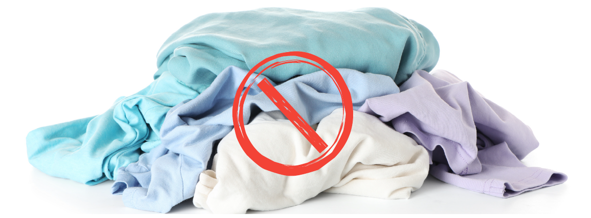 Pile of unsold clothing with a prohibition symbol, representing the EU ban on destroying unsold apparel